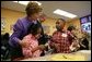 Laura Bush talks with Providence Family Support Center after-school program participants Isaiah Baynes, right, and Carlaija Whitehead during her visit and President Bush's to Pittsburgh to highlight the program's efforts to help area youth Monday, March 7, 2005.  White House photo by Susan Sterner