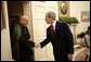 President George W. Bush welcomes Afghanistan President Hamid Karzai into the Oval Office Monday, May 23, 2005, following his arrival to the White House.  White House photo by Eric Draper