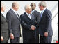 President George W. Bush is greeted by Israel’s President Shimon Peres, center, and Prime Minister Ehud Olmert after arriving in Tel Aviv Wednesday, Jan. 9, 2008, for a weeklong visit to the Mideast.  White House photo by Eric Draper