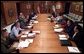 President George W. Bush meets with his war council at Camp David, Saturday morning, March 22, 2003. Present at the table are, from left, Vice Chairman of the Joint Chiefs of Staff Peter Pace, Chairman of the Joint Chiefs of Staff Richard B. Myers, Secretary of State Colin Powell, Secretary of Defense Donald Rumsfeld, Vice President Dick Cheney, Deputy Secretary of Defense Paul Wolfowitz, Chief of Staff to the Vice President Lewis Libby, Chief of Staff Andy Card, National Security Advisor Condoleezza Rice, CIA Director George Tenet, and Chief Counsel to the President Alberto Gonzalez.   White House photo by Eric Draper