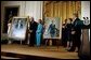 President George W. Bush and Laura Bush host the unveiling of the Clinton portraits as former President Bill Clinton and Senator Hillary Clinton stand by their official White House portraits in the East Room of the White House Monday, June 14, 2004.  White House photo by Paul Morse