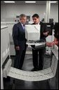 President George W. Bush and regional director Mike Colarusso tour the Department of the Treasury's Philadelphia Financial Management Service Facility July 24, 2003.  White House photo by Tina Hager