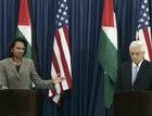 Secretary Rice and Palestinian President Mahmoud Abbas stand at podiums during a joint press conference. c AP photo