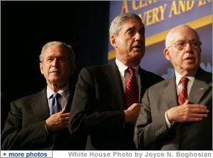 President George W. Bush joins FBI Director Robert Mueller and U.S. Attorney General Michael Mukasey during the playing of the national anthem Thursday, Oct. 30, 2008, at the graduation ceremony for FBI special agents in Quantico, Va. White House photo by Joyce N. Boghosian