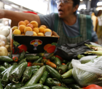 A women selling farm produce. [AP Photo 2008]