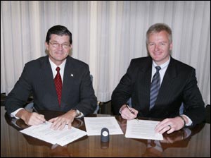 OSHA’s then-Assistant Secretary of Labor John Henshaw, and Dirk Van Holt, President of the US operation of Jungheinrich/Multion and President of the Industrial Truck Association, sign National Alliance on January 15, 2004.
