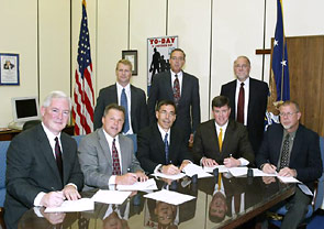 Representatives of the Material Handling Industry of America, Crane Manufacturers Association of America, Hoist Manufacturers Institute and the Monorail Manufacturers Association sign an Alliance agreement with OSHA's then-Acting Assistant Secretary, Jonathan L. Snare on October 5, 2005.