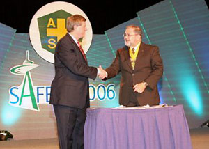 OSHA’s Assistant Secretary Edwin G. Foulke, Jr. shakes hands with ASSE's President Jack H. Dobson, Jr. after signing the OSHA and ASSE Alliance renewal agreement on June 12 at the association's 2006 Professional Development Conference in Seattle, Washington.
