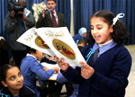Jordanian girl reading book from My Arabic Library [State Dept. Photo]