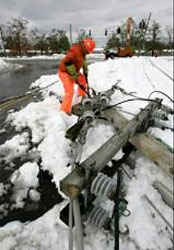 A utility worker works to restore power.
