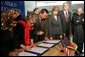 Laura Bush observes as Secretary of Education Margaret Spellings and Afghan Minister of Education Noor Mohammas Qarqeen complete the signing of the Memorandum of Understanding for funds to build a university in Kabul, Afghanistan Wednesday, March 30, 2005. White House photo by Susan Sterner