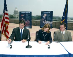 (left top right) OSHA's then-Assistant Secretary John Henshaw, and APA's Executive Director, Julie Heckman sign the Alliance as APA President Michael Collar looks on.