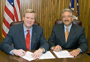 Edwin G. Foulke, Jr., Assistant Secretary, USDOL-OSHA; and Eric Allgaier, Chair, National Telecommunications Safety Panel, sign a national Alliance renewal agreement on March 26, 2008.