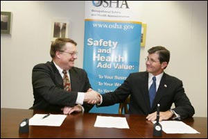 NTSP's Chair, Charles R. Slagle and OSHA's then-Assistant Secretary, John Henshaw, sign national Alliance on February 26, 2004.