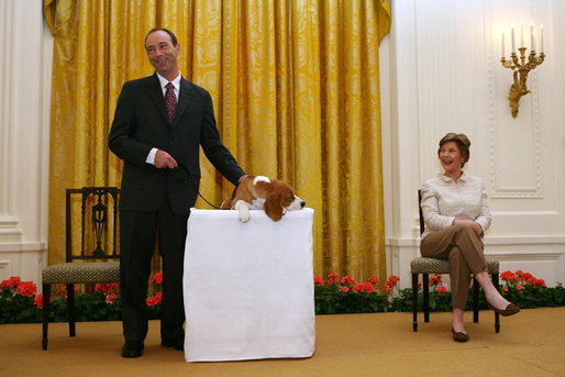 Mrs. Laura Bush looks on as the Westminster Kennel Club's 2008 Best in Show Winner, Uno, and his co-owner Eddie Dziuk address guests during their visit to the White House Monday, May 5, 2008, in the East Room of the White House. White House photo by Joyce N. Boghosian
