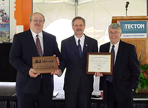 "OSHA SHARP event May, 2005." It pictures (Left to Right) Al Koch, OSHA Consulting Service, Bismarck; John Hoeven, Governor of North Dakota, and John Jambois, President of Tecton Products LLC.