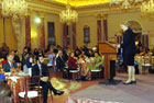 Under Secretary Karen Hughes on stage addressing the audience during the Iftaar Dinner at State Department