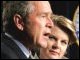 President Bush speaks at the swearing in ceremony for Margaret Spellings while she listens.