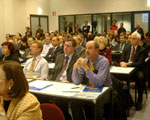 A standing-only room audience listens to the presentation on U.S. climate technology