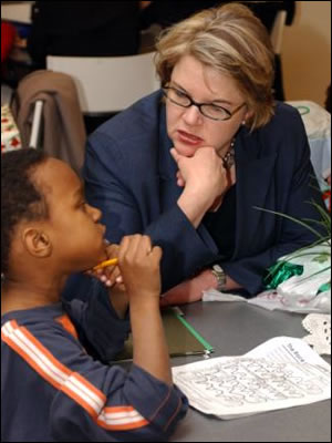 Secretary Spellings works with a D.C. public schools second-grader who participates in the Horton's Kids tutoring and mentoring program at ED.