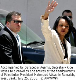Secretary Rice waves to unseen crowd.  Beside and behind her are DS special agents. Ramalah, West Bank, July 25, 2006. ,© AP/WWP,