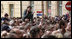 A young girl, atop the shoulders of a friend to get a better view, applauds in the crowd at Zagreb's St. Mark's Square as President George W. Bush addresses the thousands who turned out to welcome him Saturday April 5, 2008.