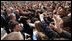 President George W. Bush reaches out to the crowd Saturday during his visit to St. Mark's Square in Zagreb. An more than 3000 people were on hand to welcome the President during his visit.