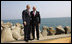 President George W. Bush and President Traian Basescu of Romania, pose for photographs Wednesday, April 2, 2008, on a seawall at the presidential retreat in Neptun, Romania. President Bush spent the day with his Romanian counterpart before the opening of the 2008 NATO Summit.