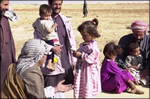 Children in the local area enjoy candy that was given to them by soldiers from the 422d Civil Affairs Battalion, Greensboro, N.C., on March 28, 2003.