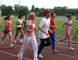 Romanian Olympic athlete Gabriela Szabo, left, and Olympic gymnast Marius Urzica, right, join in a demonstration run with DCM Mark Taplin, center, July 21, 2008.  [Ana-Maria Popa, U.S. Embassy Bucharest]
