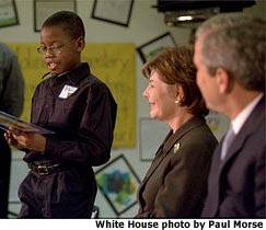 A student from a St. Louis Elementary School reads aloud for President and Mrs. Bush. White House photo by Paul Morse.