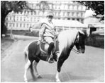 Archie Roosevelt poses with Algonquin the calico pony, June 17, 1902. Algonquin once rode in the White House elevator to visit Archie when he was ill.