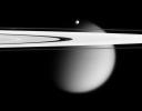 The Cassini spacecraft delivers this stunning vista showing small, 
battered Epimetheus and smog-enshrouded Titan, with Saturn's A and F 
rings stretching across the scene