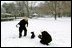 President Bush and Barney take a few moments on the South Lawn to enjoy the season's first snowfall.