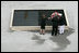 To commemorate the fifth anniversary of the terrorist attacks on September 11, 2001, President George W. Bush and Laura Bush lay a wreath in the south tower reflecting pool at the World Trade Center site in New York City Sunday, September 10, 2006.