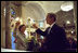 President George W. Bush and First Lady Laura Bush light a candle at St. John Episcopal Church in Washington, D.C., during a private service of prayer and remembrance Wednesday morning, September 11, 2002.