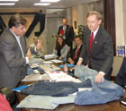 Deputy Secretary Zoellick examines jeans and clothing accessories made at the Koramsa plant in Guatemala City, Guatemala.