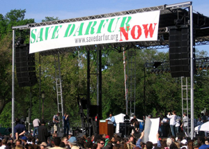 Assistant Frazer speaking under Save Darfur banner before large crown on the Mall [State Department Photo April 2006]
