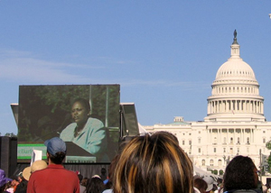 Assistant Secretary Frazer appears on large screen during the Save Darfur rally with the Capitol Dome in the background. [State Department Photo April 2006]