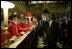 After listening to the Westminster Abbey Choir perform, President George W. Bush greets one of the younger choir members during his and Mrs. Bush's tour of the abbey Thursday, Nov. 20, 2003. White House photo by Eric Draper