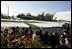 Visitors wave as President Bush takes off in Marine One from a snow-covered South Lawn Friday, Dec. 9, 2005.