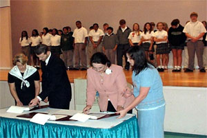From left to right: Patty Hughston, Mobile County School Board Representative; Ken Atha, Area Director, Mobile Area Office, USDOL-OSHA; Sandra Frobus, Mobile United Official; and Janice Bequette, President, Mobile Chapter ASSE. The children, in the background are from Sims Middle School and Adams Middle School in Mobile, Alabama