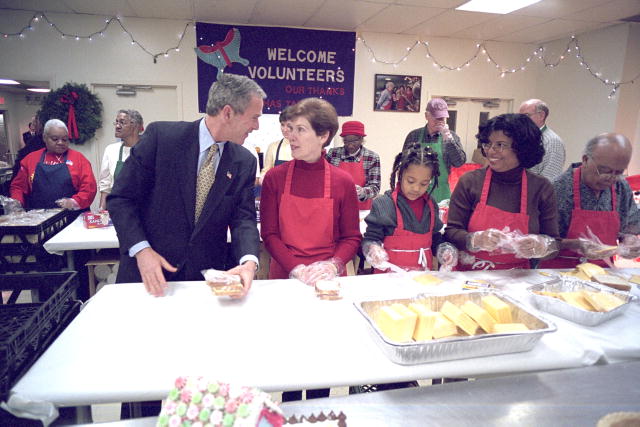 President Bush talks with a volunteer at a center for homeless adults and children.