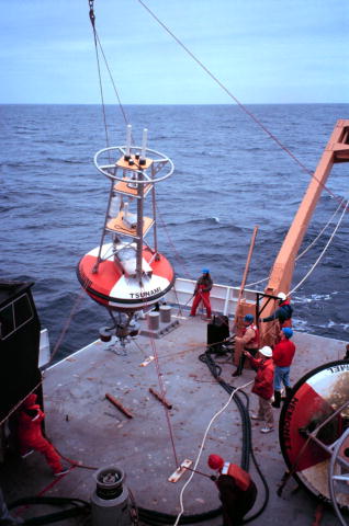 The photo shows a tsunami buoy being deployed as part of the U.S. National Tsunami Hazard Mitigation Program maintained by the National Oceanic and Atmospheric Administration.