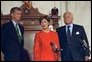 Laura Bush addresses the media in the Senate Russell Office Building Sept. 11, 2001. Standing with Mrs. Bush is Sen. Judd Gregg, left, and Sen. Edward Kennedy. White House photo by Moreen Ishikawa