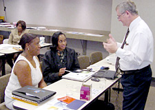 A representative from the Louisiana Department of Labor talks to job seekers about employment opportunities.