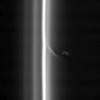 This view shows Prometheus with a streamer it has created in the inner edge of the F ring. Prometheus comes close to the inner edge of the ring once per orbit, perturbing the ring particles there