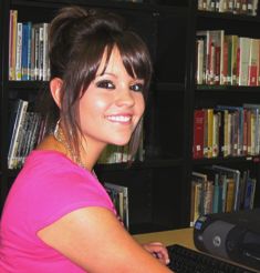 Image of Morgan J sitting in front of a school library computer workstation
