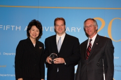 Secretary of Labor Elaine L. Chao (L) and Assistant Secretary of Labor for Disability Employment Policy W. Roy Grizzard (R) present a 2006 Secretary of Labor's New Freedom Initiative Award to Jack Lavin, Director, Illinois Department of Commerce and Economic Opportunity, who accepted the award for disabilityworks, Chicagoland Chamber of Commerce. (DOL Photo/Shawn Moore)