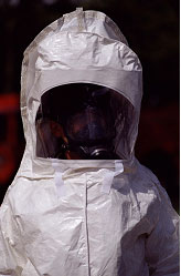 A health worker stands in a protective hazardous materials suit.